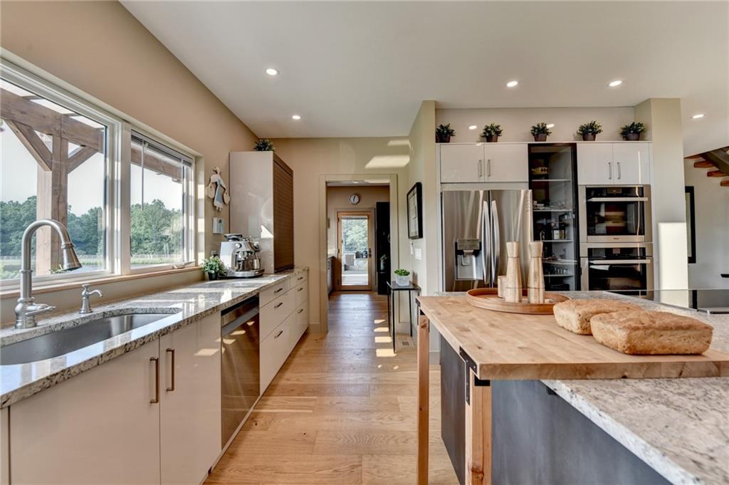 120 Mt Moriah Road Auburn, GA 30011 - Photo 21 of 48 a large kitchen with stainless steel appliances granite countertop plenty wooden cabinets counter space and a sink