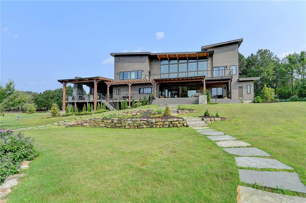 120 Mt Moriah Road Auburn, GA 30011 - Photo 4 of 48 a front view of a house with swimming pool having outdoor seating