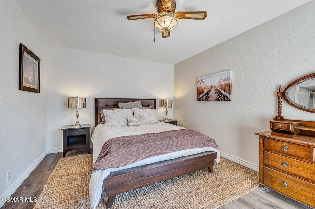 11780 Barranca Road Camarillo, CA 93012 - Photo 22 of 26 a bedroom with a bed and wooden floor