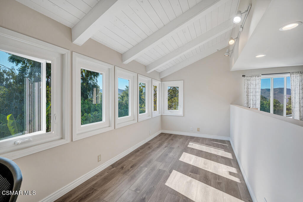 11780 Barranca Road Camarillo, CA 93012 - Photo 8 of 26 a view of an empty room with wooden floor and a window