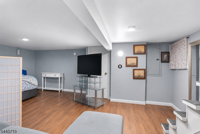 136 Smith Street Elizabeth, NJ 07201 - Photo 31 of 38 a view of a livingroom with furniture and a flat screen tv