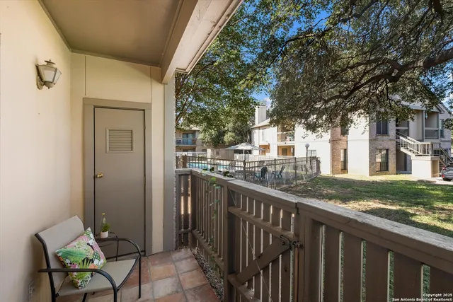 a view of a house with backyard and sitting area