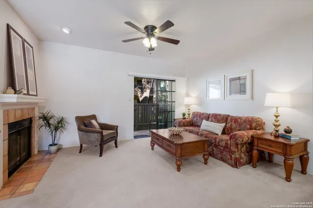 a living room with furniture and a fireplace