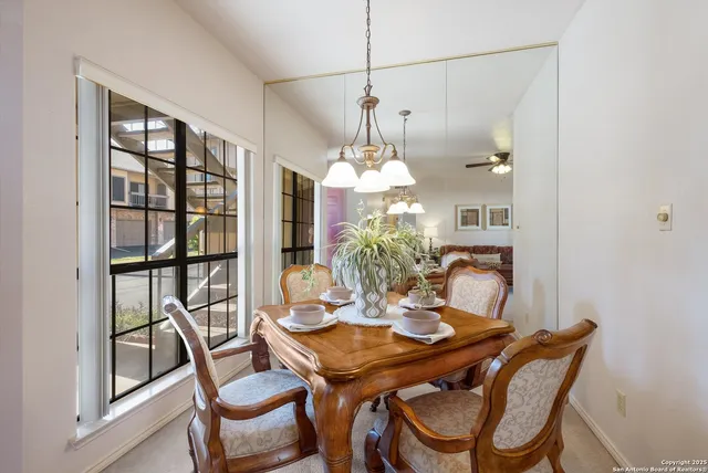 a view of a dining room with furniture and a chandelier