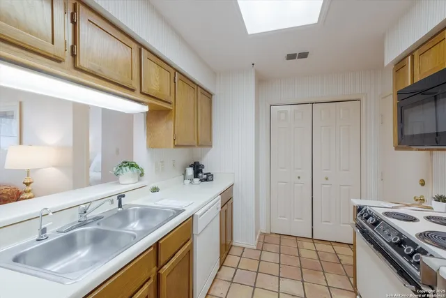 a kitchen with a sink stove and cabinets