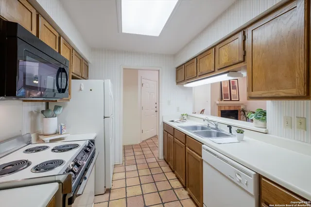 a kitchen with a stove and a refrigerator