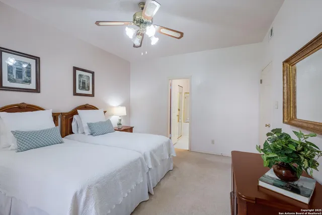a bedroom with bed and a chandelier
