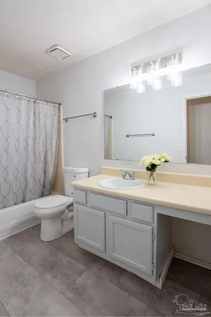 a bathroom with a sink a toilet and bathtub