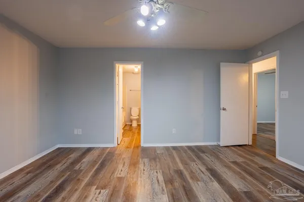 a view of an empty room and wooden floor