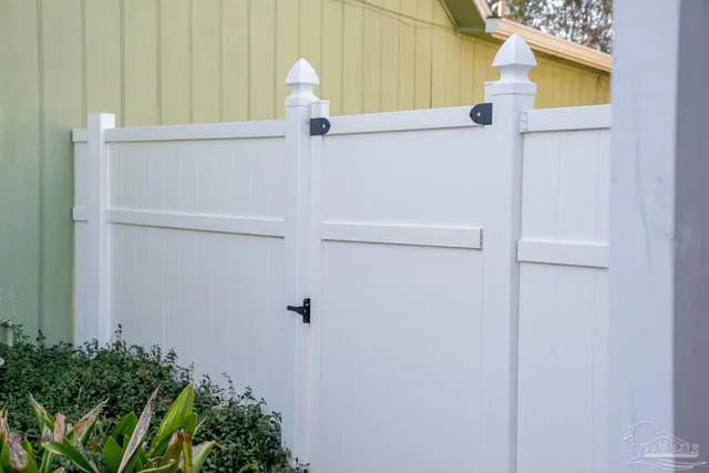 a view of a backyard with garden and furniture