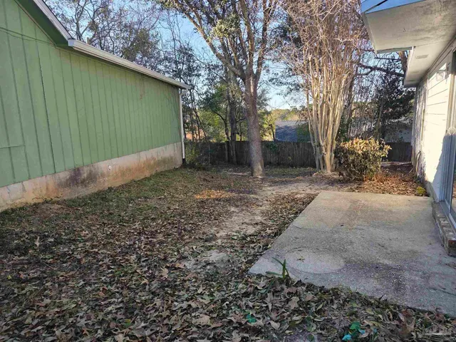 a backyard of a house with lots of green space