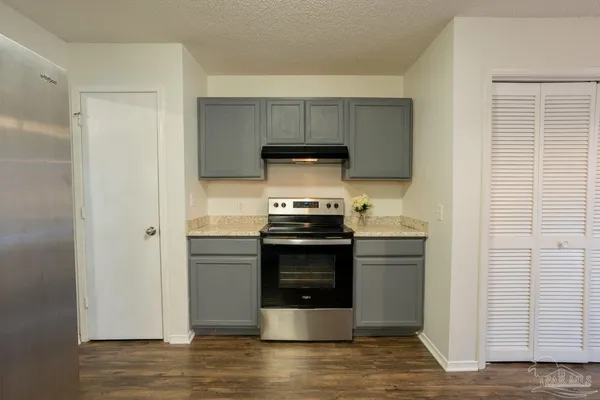 a kitchen with a stove and a refrigerator