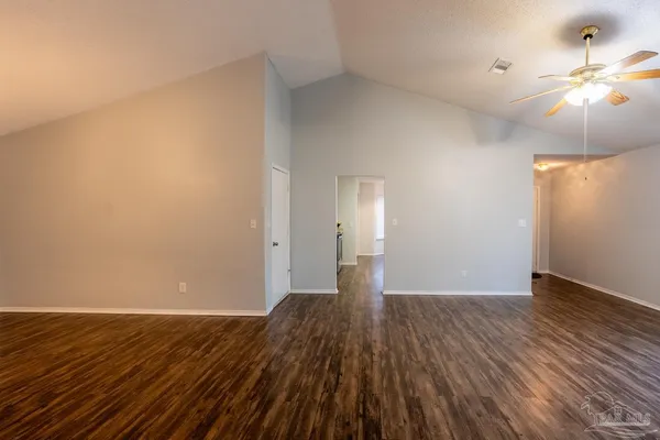 a view of an empty room and wooden floor