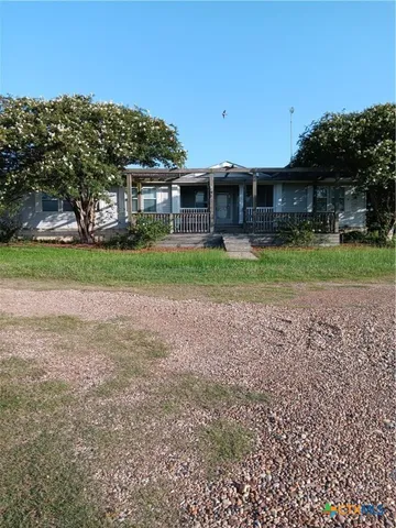 a view of a house with a back yard
