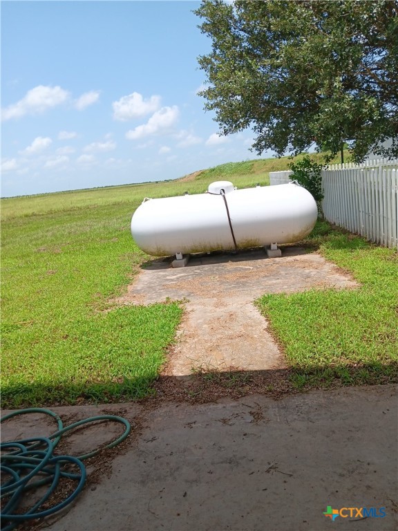 490 Adcock Ranch Road Victoria, TX 77904 - Photo 9 of 10 a view of a backyard with lawn chairs and iron fence