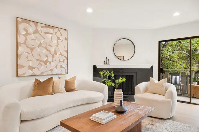 a living room with furniture a lamp and a large window
