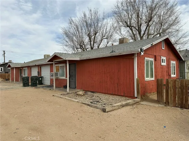 a view of a house with a yard covered in snow