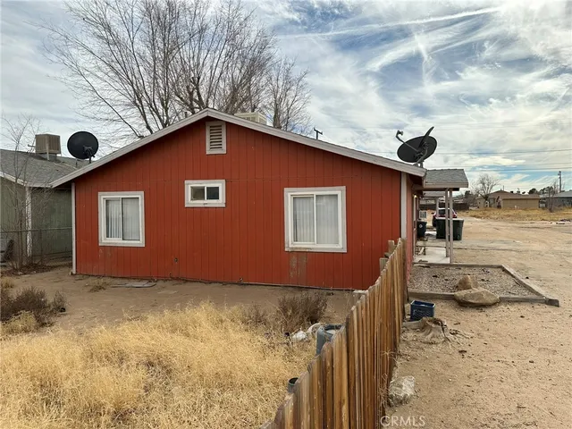 a backyard of a house with wooden fence