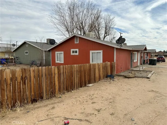 a front view of a house with a wooden fence