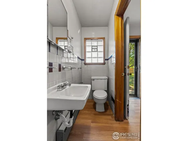 a bathroom with a sink toilet and mirror