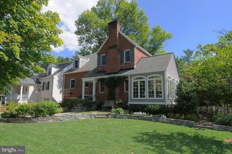 7403 Denton Road Bethesda, MD 20814 - Photo 1 of 25 a front view of a house with a yard and trees