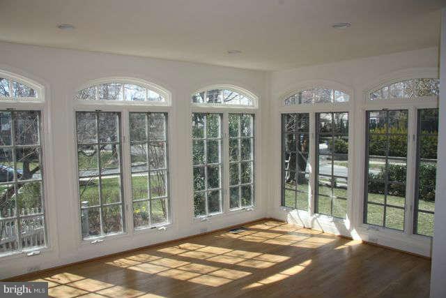 7403 Denton Road Bethesda, MD 20814 - Photo 11 of 25 a view of a spacious bedroom with balcony and windows