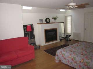 7403 Denton Road Bethesda, MD 20814 - Photo 16 of 25 a bed room with a bed and a fireplace