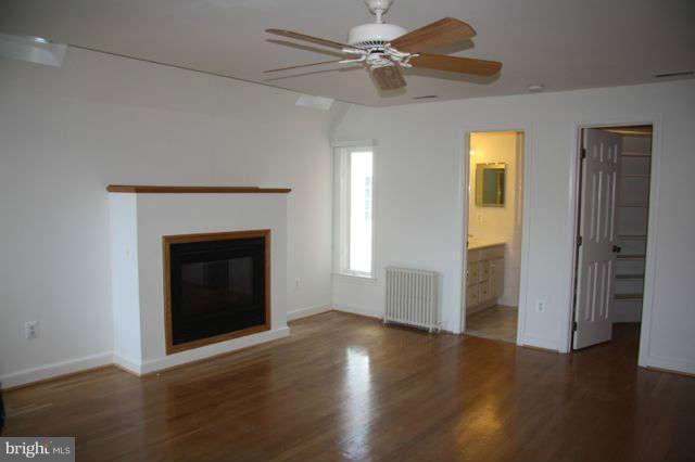 7403 Denton Road Bethesda, MD 20814 - Photo 17 of 25 a view of a livingroom with a fireplace a ceiling fan and hardwood floor