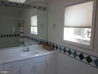 7403 Denton Road Bethesda, MD 20814 - Photo 18 of 25 a bathroom with a double vanity sink and a mirror