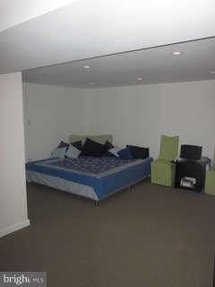 7403 Denton Road Bethesda, MD 20814 - Photo 25 of 25 a bed sitting in a room next to a lamp