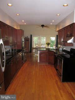7403 Denton Road Bethesda, MD 20814 - Photo 4 of 25 a large kitchen with stainless steel appliances lots of counter top space