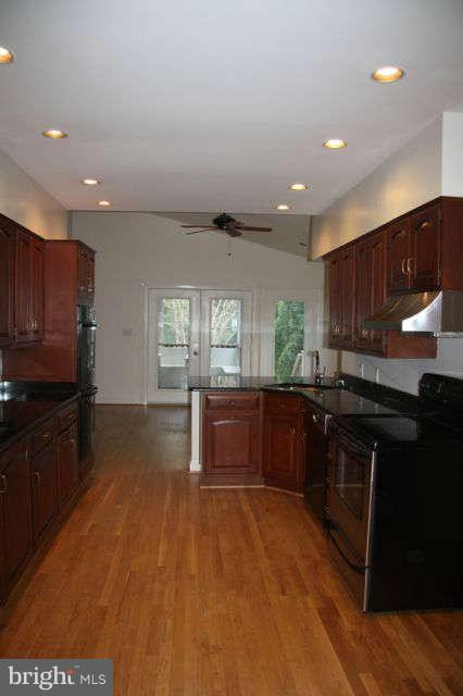 7403 Denton Road Bethesda, MD 20814 - Photo 5 of 25 a kitchen with granite countertop a stove and refrigerator