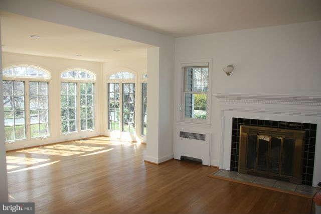7403 Denton Road Bethesda, MD 20814 - Photo 9 of 25 a view of an empty room with a fireplace and a window