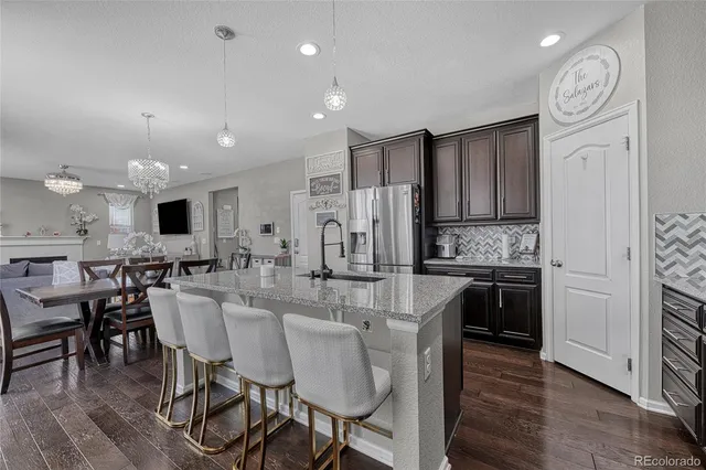 a large kitchen with a table and chairs