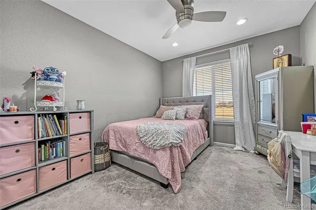 a bedroom with a bed cabinets and book shelf