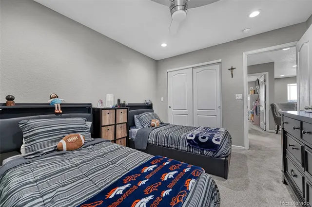 a bedroom with two beds and a chandelier