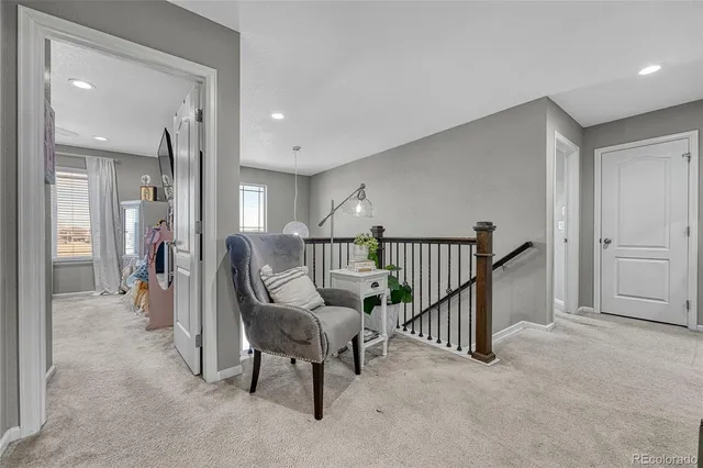 a view of a hallway with seating area