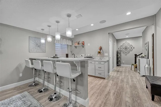 a kitchen with a sink cabinets and wooden floor
