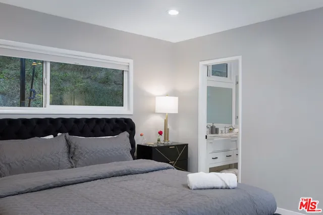 a bedroom with a bed and a window