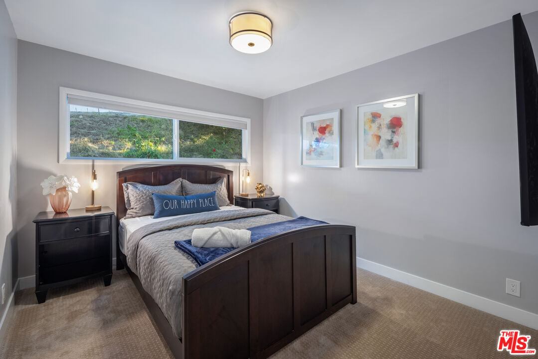 9476 Hidden Valley Place Beverly Hills, CA 90210 - Photo 18 of 43 a bedroom with bed and a window