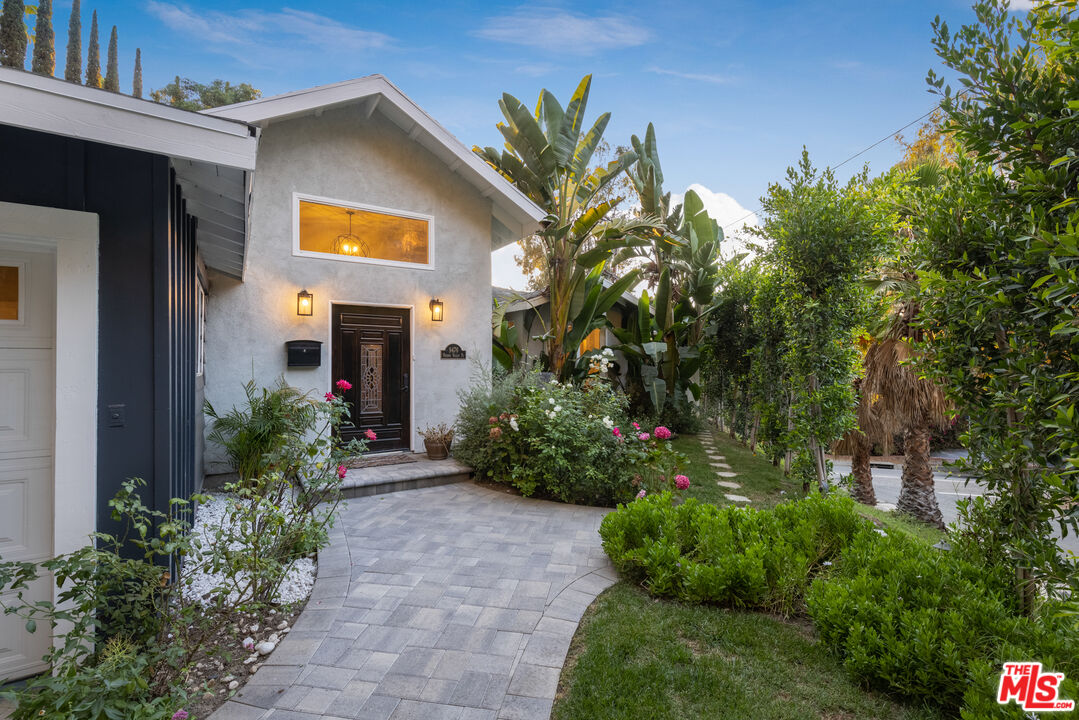 9476 Hidden Valley Place Beverly Hills, CA 90210 - Photo 24 of 43 a front view of a house with a yard