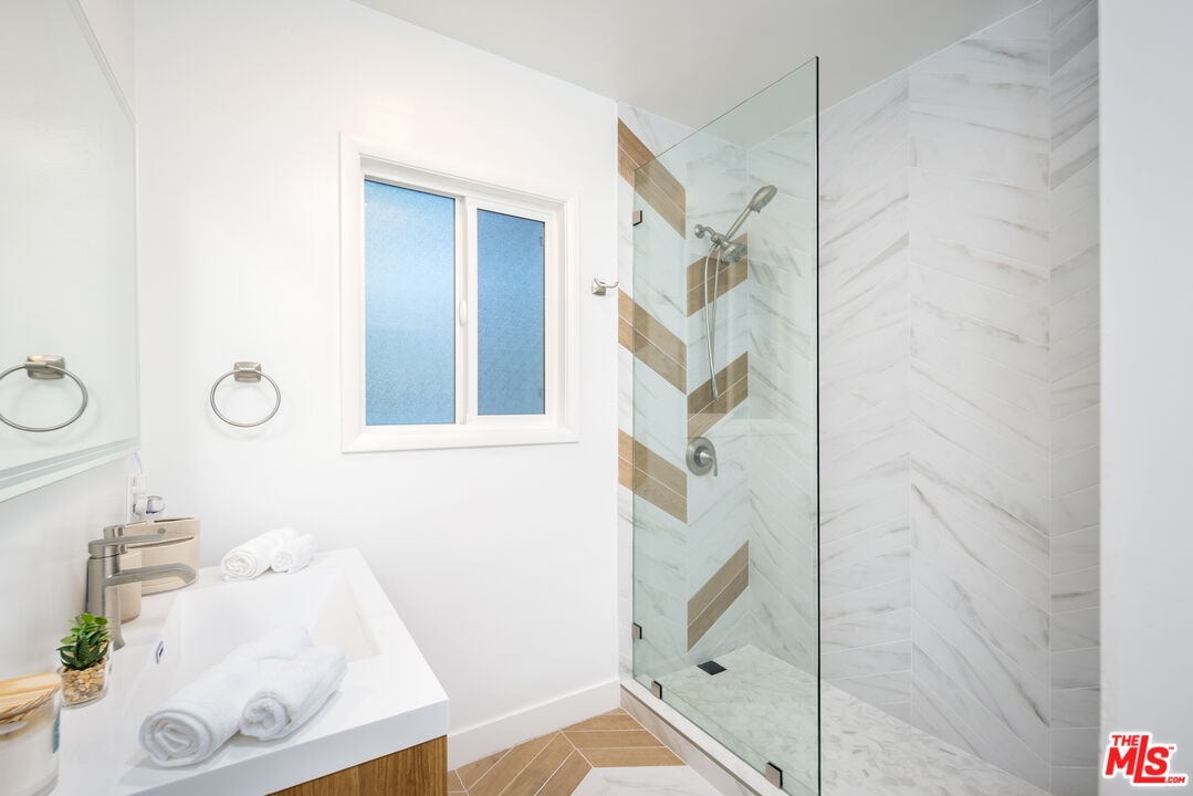 9476 Hidden Valley Place Beverly Hills, CA 90210 - Photo 25 of 43 a bathroom with a bathtub and shower