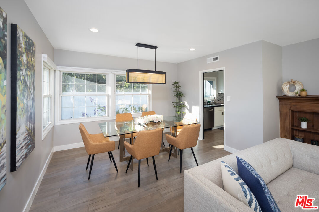 9476 Hidden Valley Place Beverly Hills, CA 90210 - Photo 28 of 43 a view of a dining room with furniture window and wooden floor