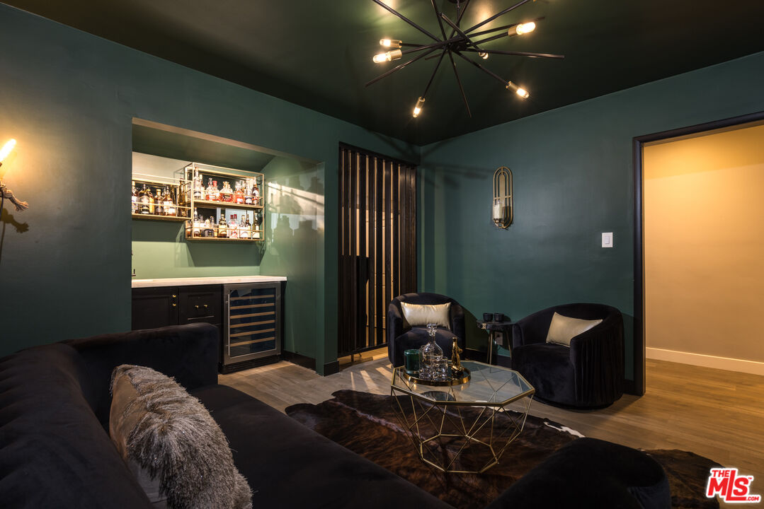 9476 Hidden Valley Place Beverly Hills, CA 90210 - Photo 30 of 43 a living room with furniture and a flat screen tv