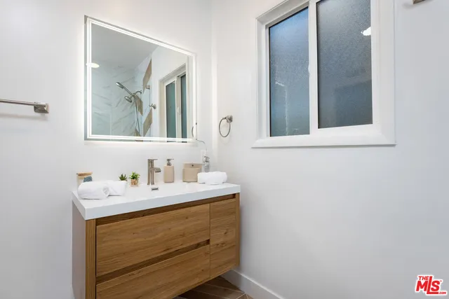 a bathroom with a tub sink and mirror
