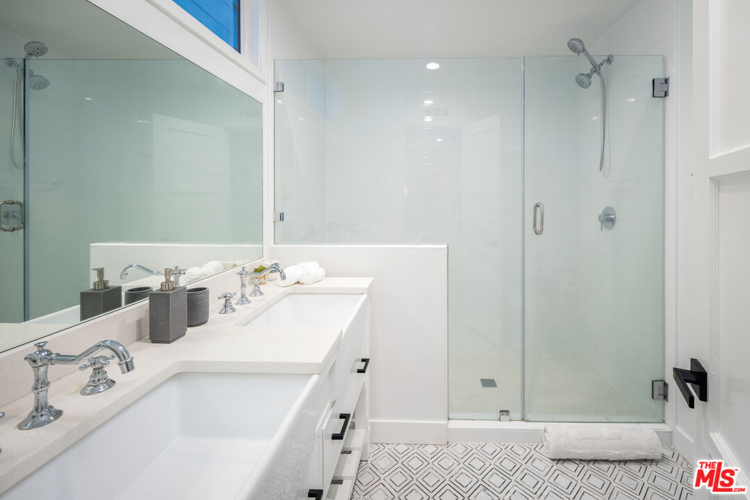 9476 Hidden Valley Place Beverly Hills, CA 90210 - Photo 32 of 43 a bathroom with a tub sink and mirror