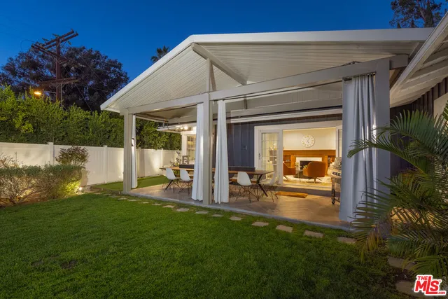 a living room with furniture a projector and a flat screen tv
