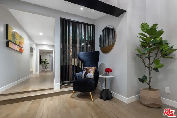 a dining room with furniture window and wooden floor