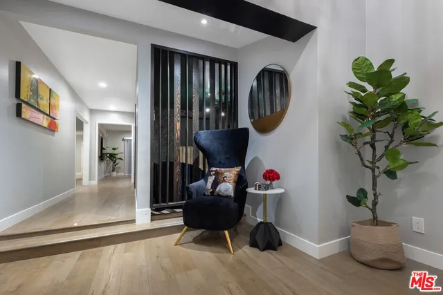 a dining room with furniture window and wooden floor