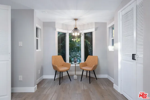 a living room with furniture a fireplace and a large window